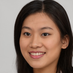 Joyful asian young-adult female with long  brown hair and brown eyes