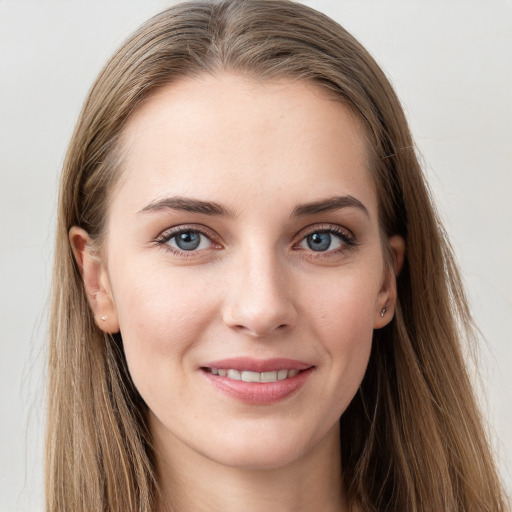 Joyful white young-adult female with long  brown hair and grey eyes