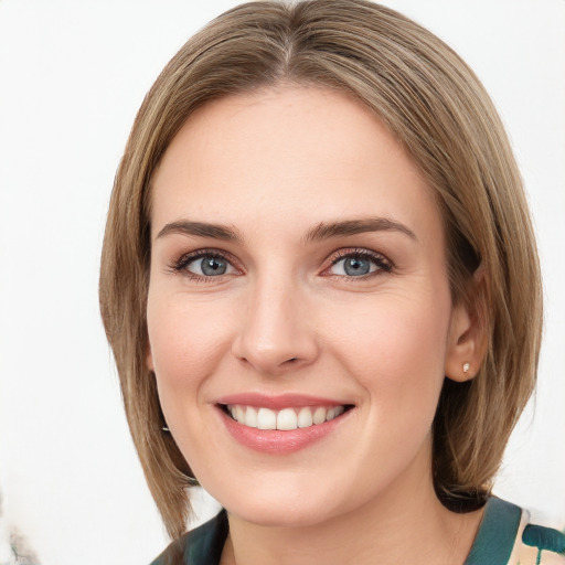 Joyful white young-adult female with medium  brown hair and green eyes