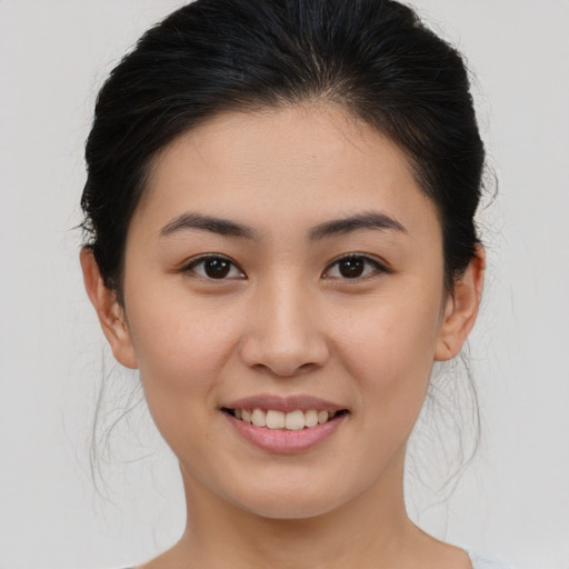 Joyful asian young-adult female with medium  brown hair and brown eyes