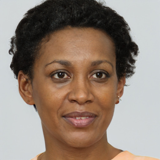 Joyful black adult female with short  brown hair and brown eyes