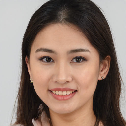 Joyful white young-adult female with long  brown hair and brown eyes