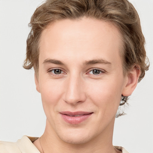 Joyful white young-adult female with short  brown hair and grey eyes