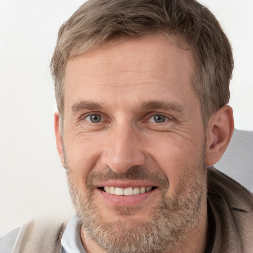 Joyful white adult male with short  brown hair and grey eyes