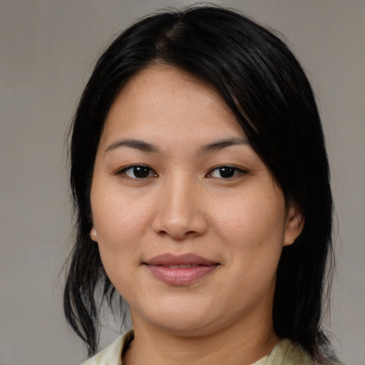 Joyful asian young-adult female with medium  black hair and brown eyes