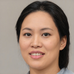 Joyful asian young-adult female with medium  brown hair and brown eyes