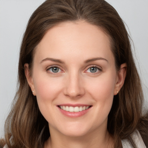 Joyful white young-adult female with long  brown hair and grey eyes