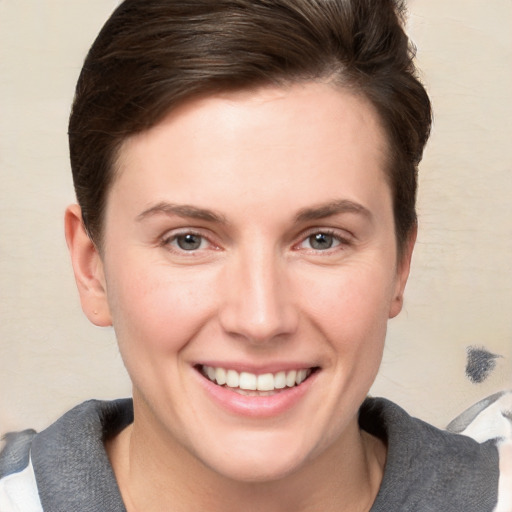 Joyful white young-adult female with short  brown hair and grey eyes