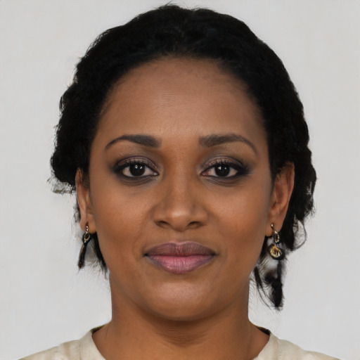 Joyful black young-adult female with medium  black hair and brown eyes