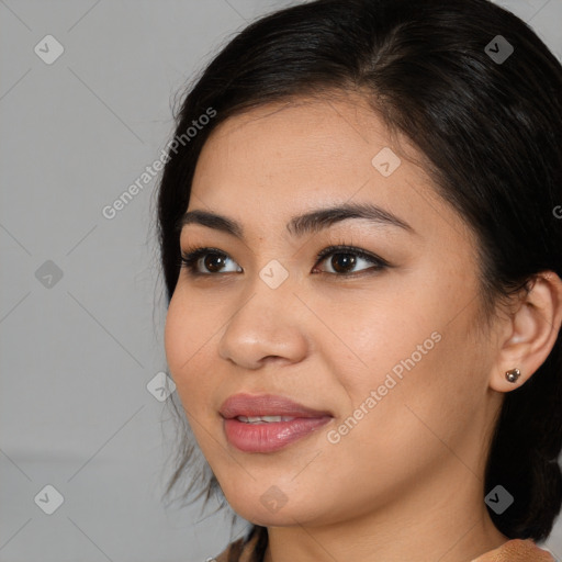 Joyful latino young-adult female with medium  brown hair and brown eyes