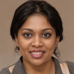 Joyful black young-adult female with medium  brown hair and brown eyes