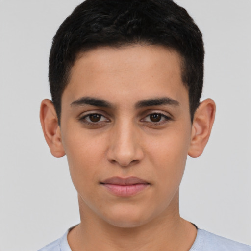 Joyful latino young-adult male with short  black hair and brown eyes