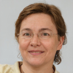 Joyful white adult female with medium  brown hair and grey eyes