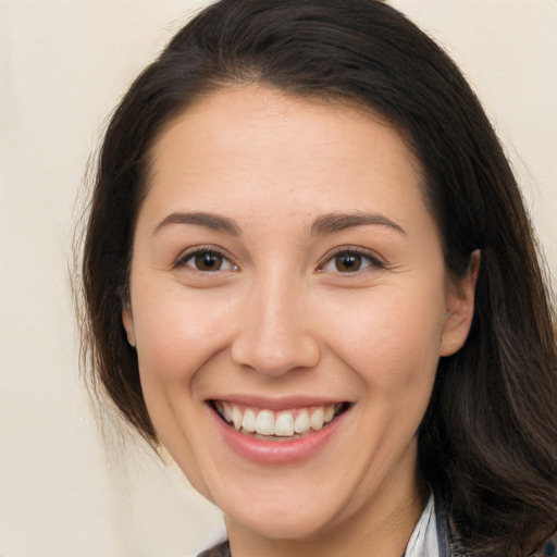 Joyful white young-adult female with long  brown hair and brown eyes