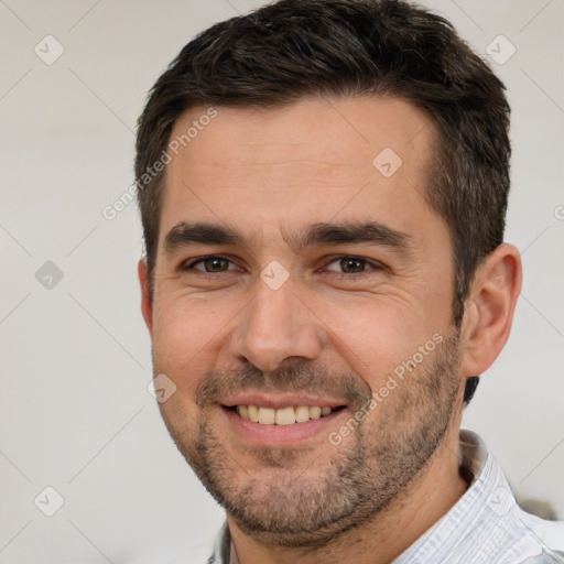 Joyful white adult male with short  brown hair and brown eyes