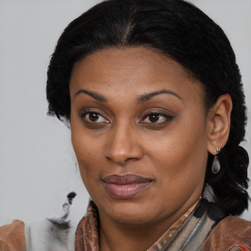 Joyful black adult female with medium  brown hair and brown eyes