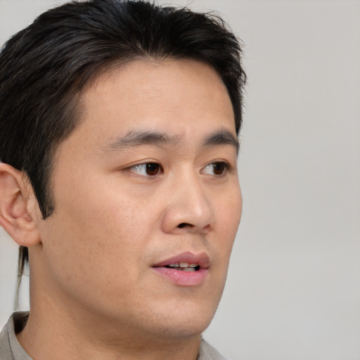 Neutral asian young-adult male with short  brown hair and brown eyes