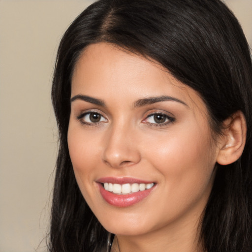 Joyful white young-adult female with long  black hair and brown eyes