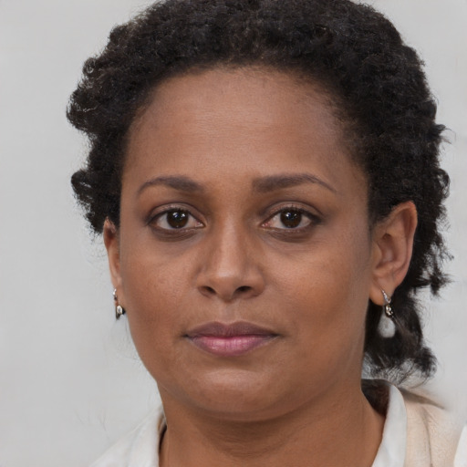 Neutral black adult female with short  brown hair and brown eyes