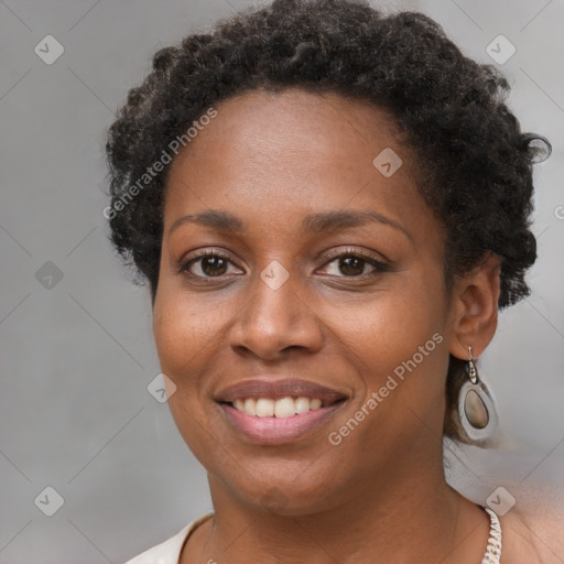 Joyful black young-adult female with short  brown hair and brown eyes