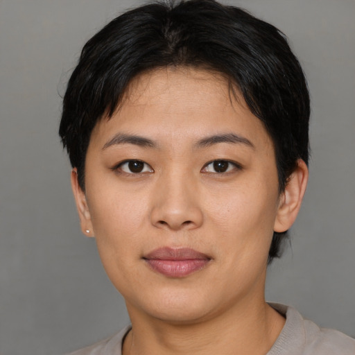 Joyful asian young-adult female with short  brown hair and brown eyes