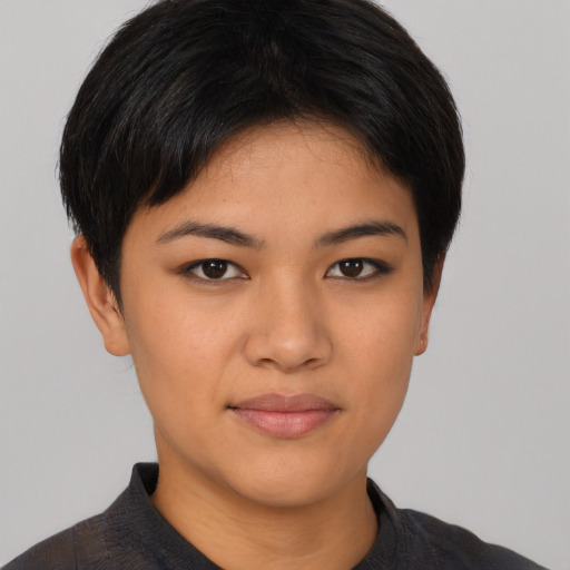 Joyful asian young-adult female with short  black hair and brown eyes