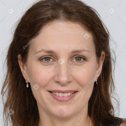 Joyful white adult female with long  brown hair and grey eyes