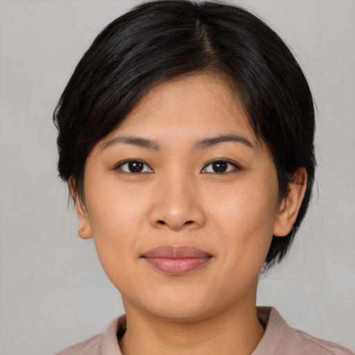 Joyful latino young-adult female with medium  black hair and brown eyes