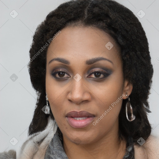 Joyful black young-adult female with long  black hair and brown eyes