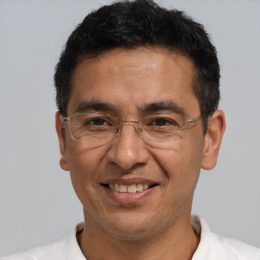 Joyful white adult male with short  black hair and brown eyes