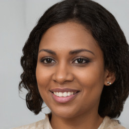 Joyful black young-adult female with medium  brown hair and brown eyes