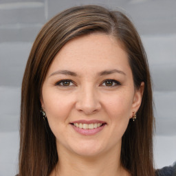 Joyful white young-adult female with long  brown hair and brown eyes