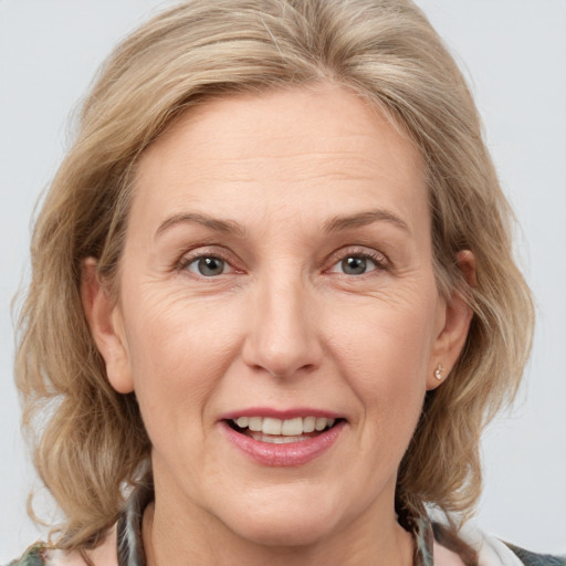 Joyful white adult female with medium  brown hair and grey eyes