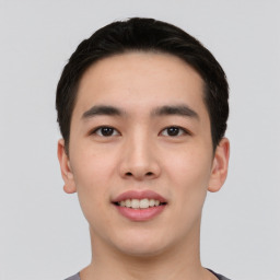 Joyful asian young-adult male with short  black hair and brown eyes