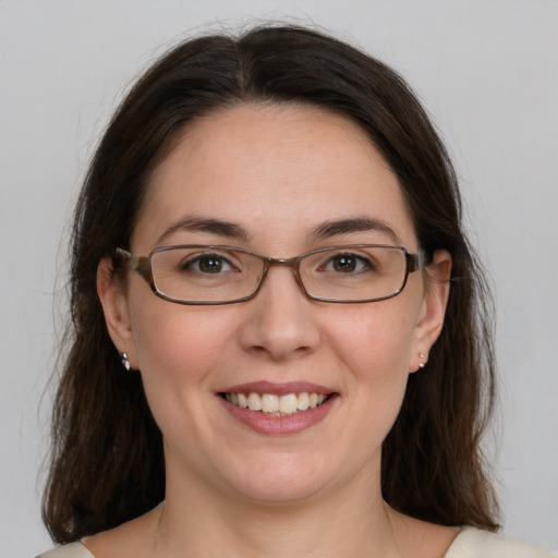 Joyful white young-adult female with medium  brown hair and grey eyes