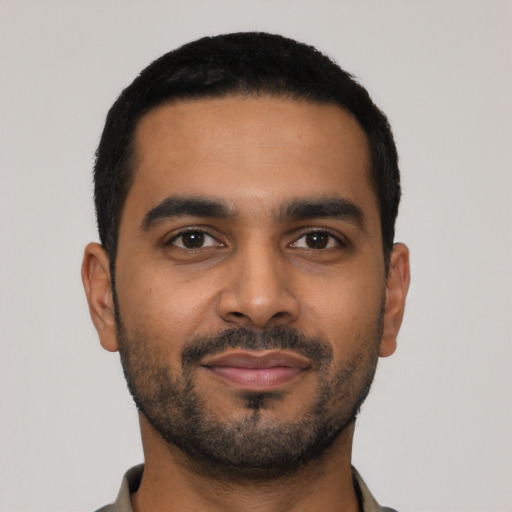 Joyful latino young-adult male with short  black hair and brown eyes