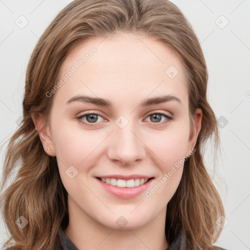 Joyful white young-adult female with long  brown hair and blue eyes