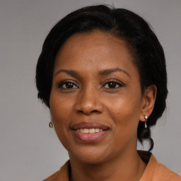 Joyful black adult female with medium  black hair and brown eyes
