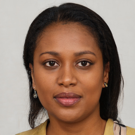 Joyful black young-adult female with medium  brown hair and brown eyes