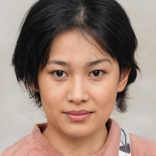 Joyful asian young-adult female with medium  brown hair and brown eyes
