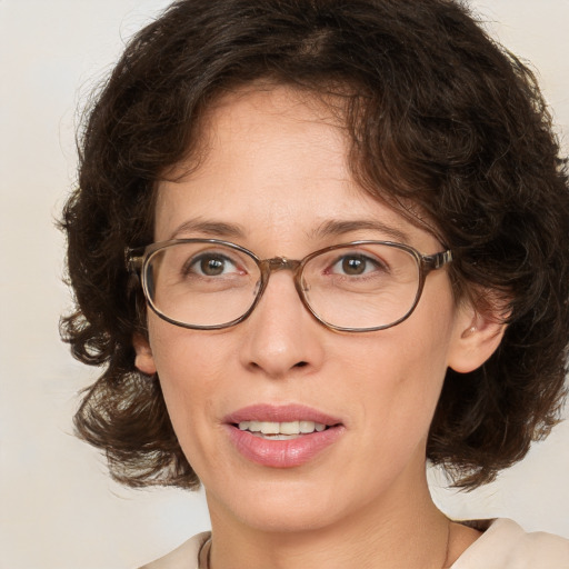 Joyful white adult female with medium  brown hair and green eyes