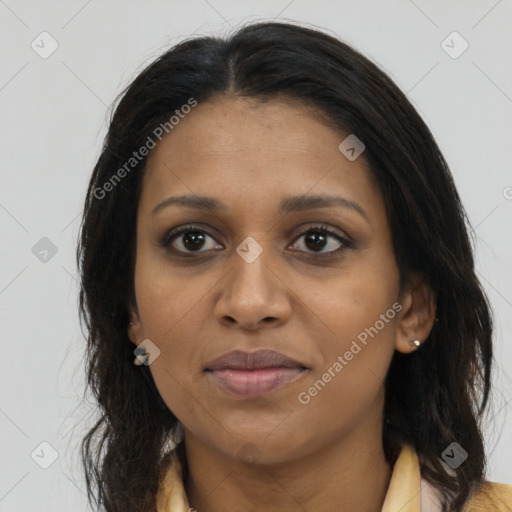 Joyful black young-adult female with long  brown hair and brown eyes