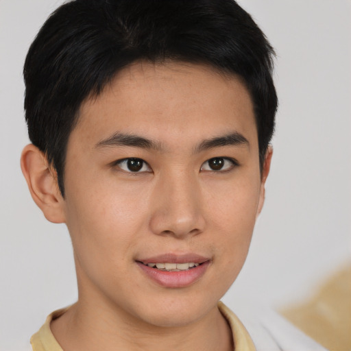 Joyful asian young-adult male with short  brown hair and brown eyes