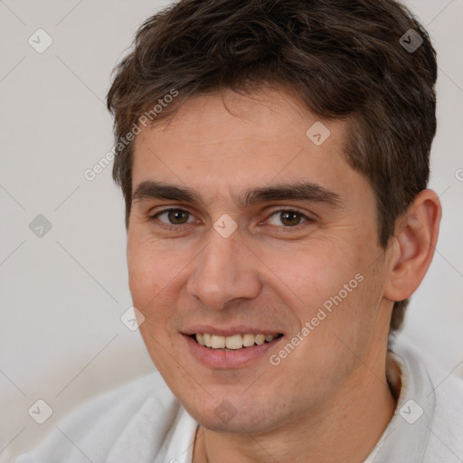 Joyful white young-adult male with short  brown hair and brown eyes