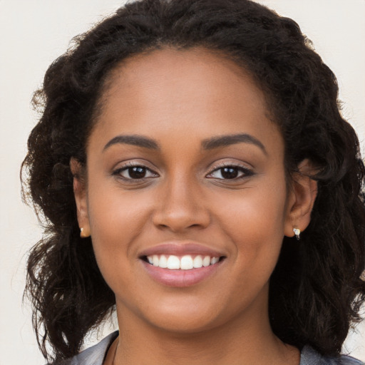 Joyful latino young-adult female with long  brown hair and brown eyes