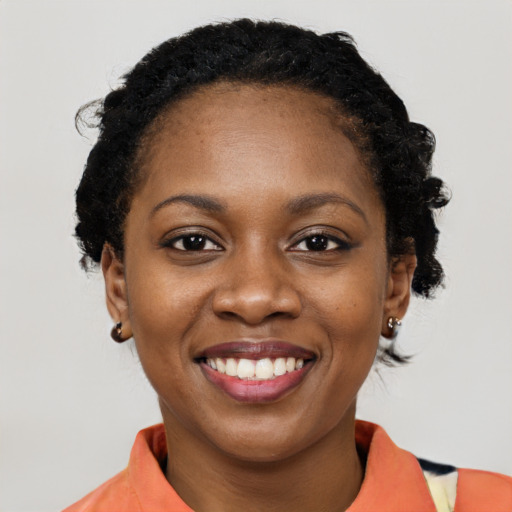Joyful black young-adult female with medium  black hair and brown eyes