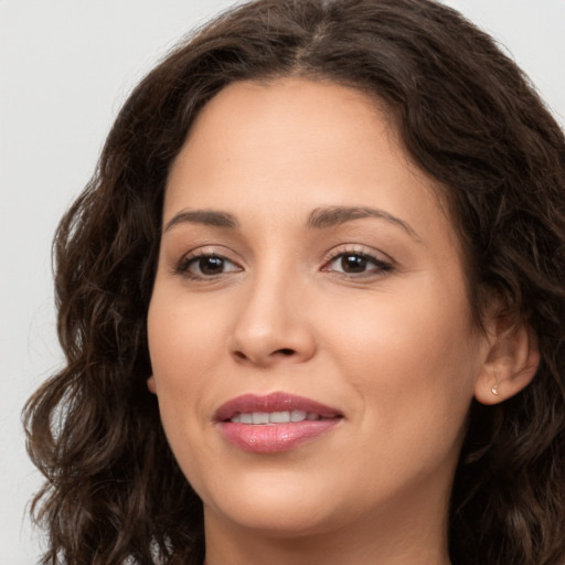 Joyful white young-adult female with long  brown hair and brown eyes