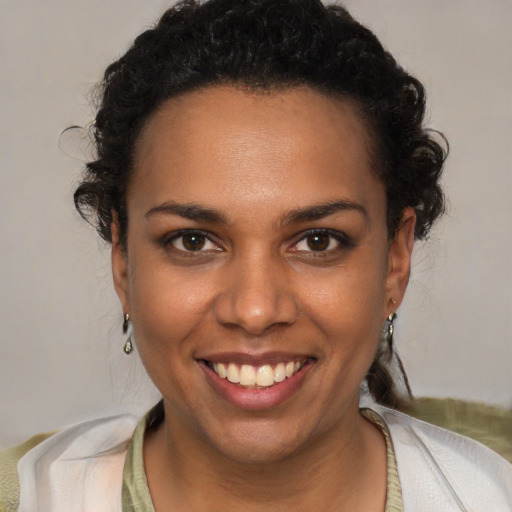 Joyful black young-adult female with short  brown hair and brown eyes