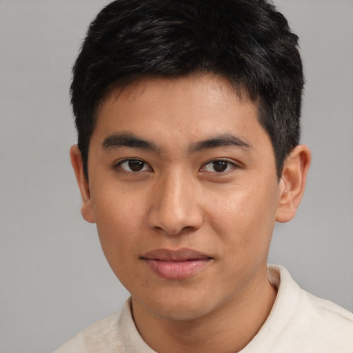 Joyful asian young-adult male with short  black hair and brown eyes