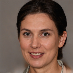 Joyful white adult female with medium  brown hair and brown eyes